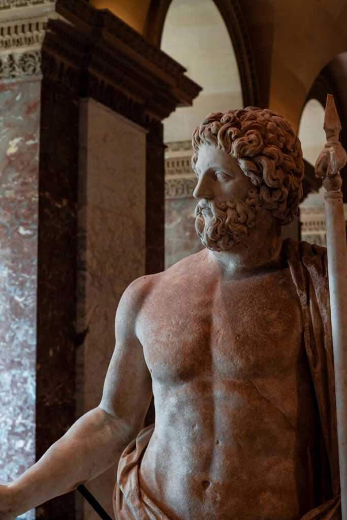 A detailed view of a Zeus sculpture in a renowned museum, showcasing classical art.