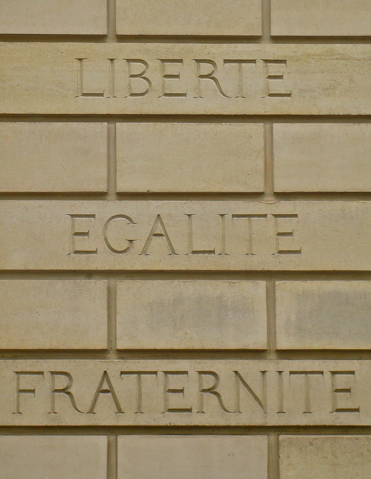 Égalité en franc-maçonnerie – French motto 'Liberté égalité fraternité' on a brickwall